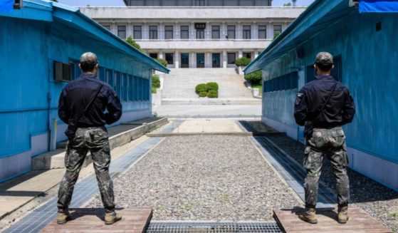 Two South Korean soldiers stand guard as they face North Korea's Panmon Hall in the truce village of Panmunjom in the Joint Security Area of the Demilitarized Zone on May 9.