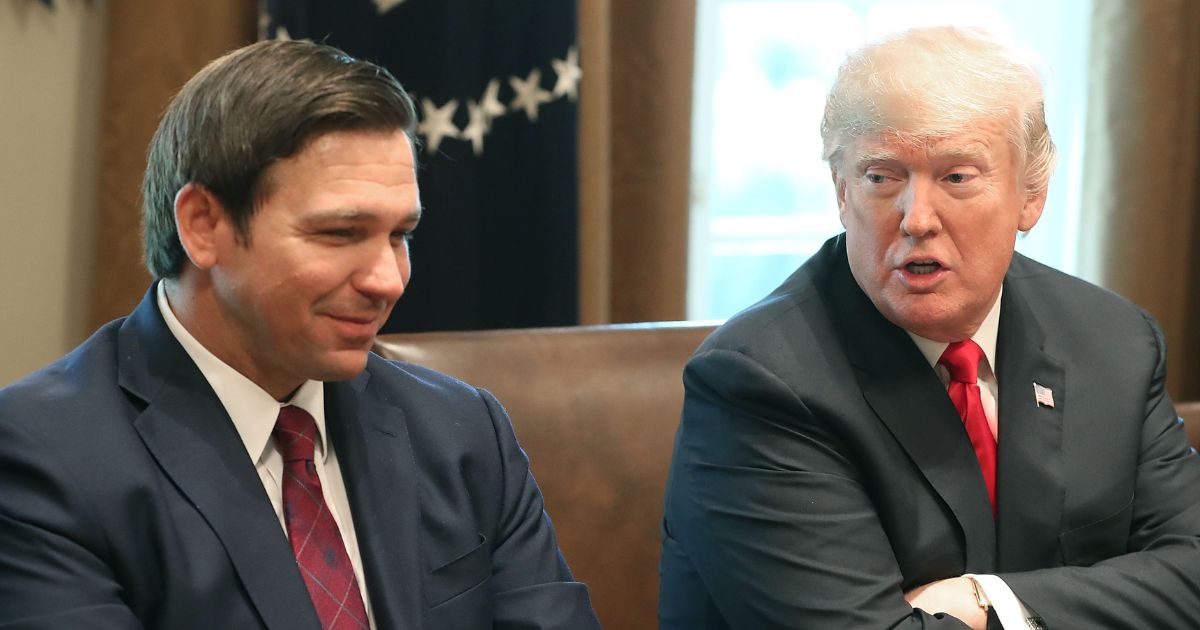 Then-Florida Governor-elect Ron DeSantis, left, is seen with then-President Donald Trump during a meeting at the White House in 2018. The two are the top-earning GOP candidates in the 2024 race.