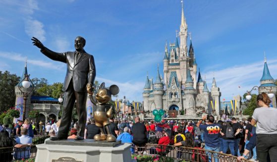 A statue of Walt Disney and Micky Mouse stands in front of the Cinderella Castle at the Magic Kingdom at Walt Disney World in Lake Buena Vista, Florida, on Jan. 9, 2019.
