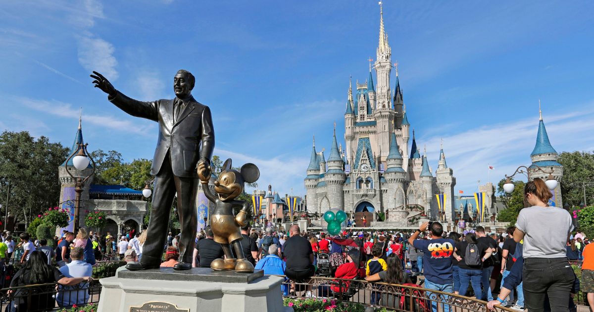 A statue of Walt Disney and Micky Mouse stands in front of the Cinderella Castle at the Magic Kingdom at Walt Disney World in Lake Buena Vista, Florida, on Jan. 9, 2019.