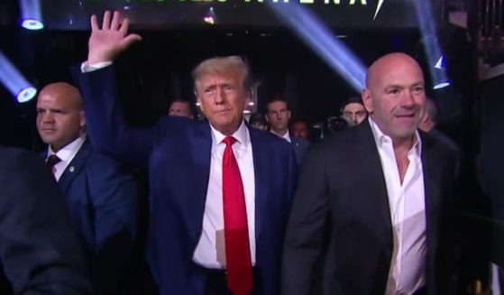 Former President Donald Trump, middle, arrives at UFC 290 with UFC President Dana White, right, at T-Mobile Arena in Las Vegas on Saturday.
