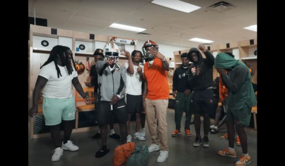 In a screenshot from the music video "Send A Blitz," rapper Real Boston Richey may have just cost numerous players scholarships and their football careers in his latest video.