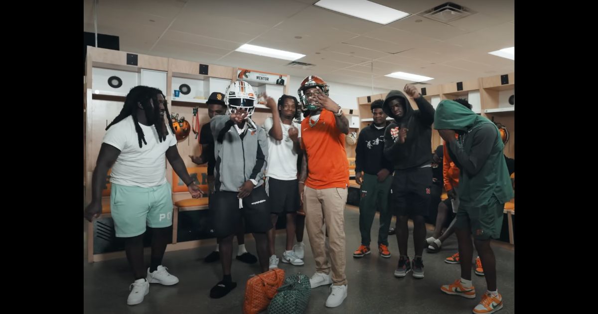 In a screenshot from the music video "Send A Blitz," rapper Real Boston Richey may have just cost numerous players scholarships and their football careers in his latest video.