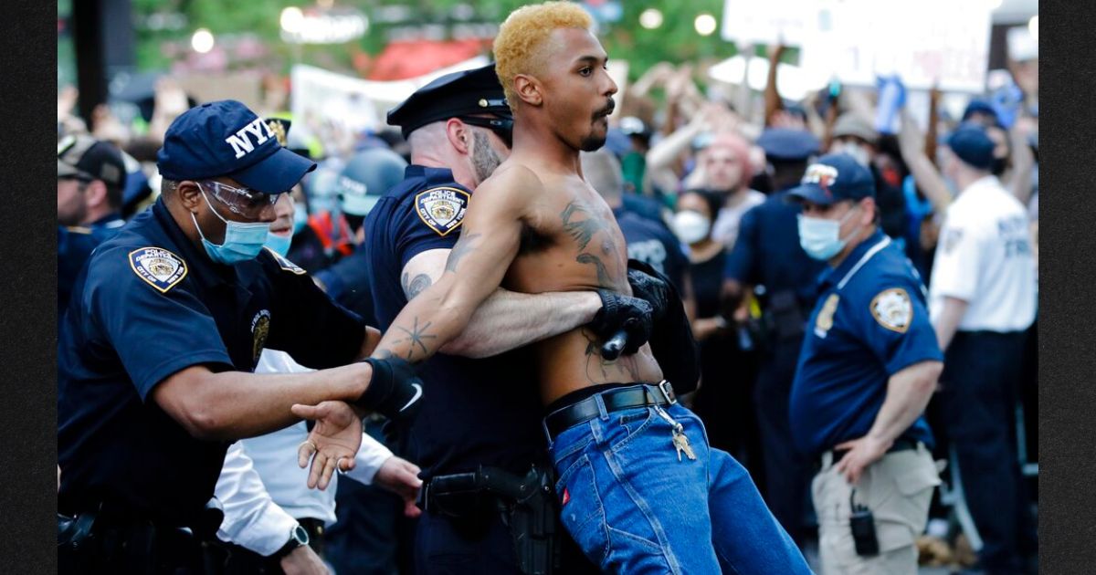 A protester is arrested May 29, 2020, at New York's Barclays Center during a rally over the death of George Floyd in police custody in Minneapolis. New York City proposes to pay a $13 million settlement to protesters for violating their First-Amendment right to free speech