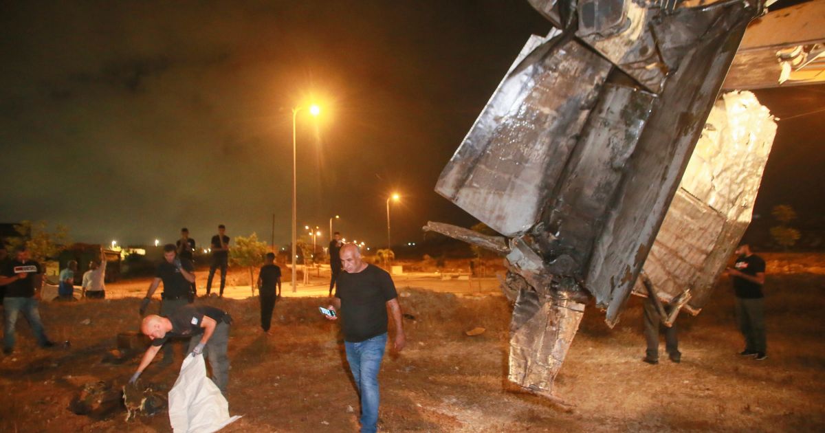 Israeli authorities inspect the remains of what the Israeli military said is a Syrian anti-aircraft rocket that exploded in the air, in the town of Rahat, Israel, on Sunday.
