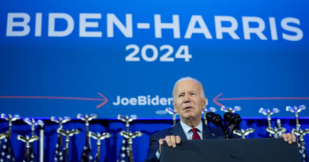 President Joe Biden speaks in front of a "Biden-Harris 2024" banner in Washington on June 23.