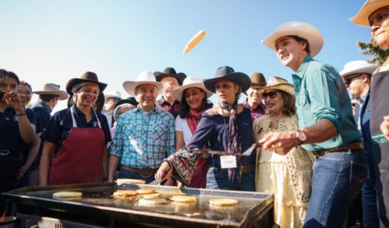Canadian Prime Minister Justin Trudeau, second from right, was seen flipping pancakes at a stampede breakfast in Calgary on Saturday.