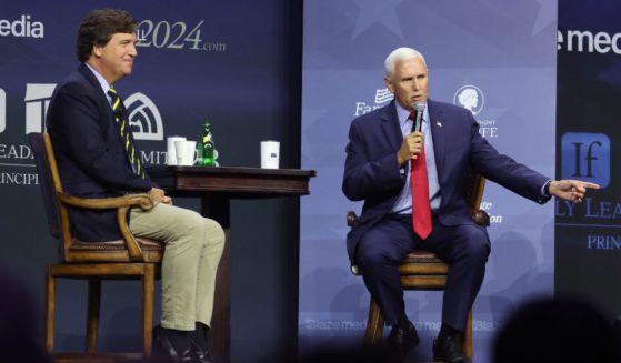 Former Vice President Mike Pence fields questions from former Fox News personality Tucker Carlson at the Family Leadership Summit on Friday in Des Moines, Iowa.