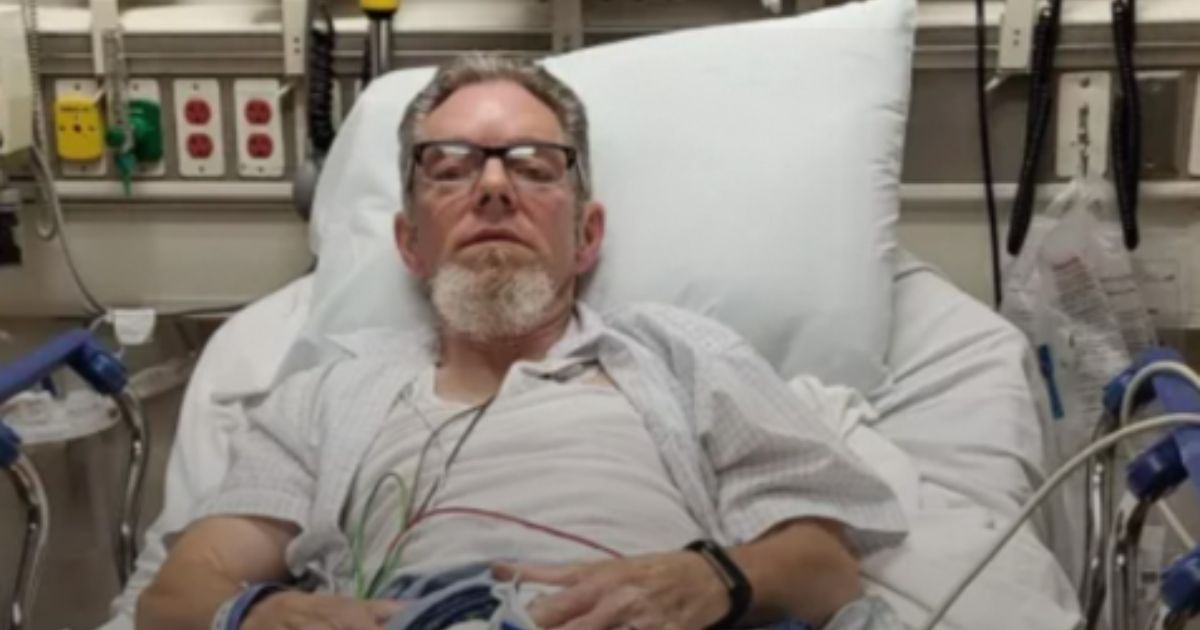 Mark Zimmerman lying in a hospital bed