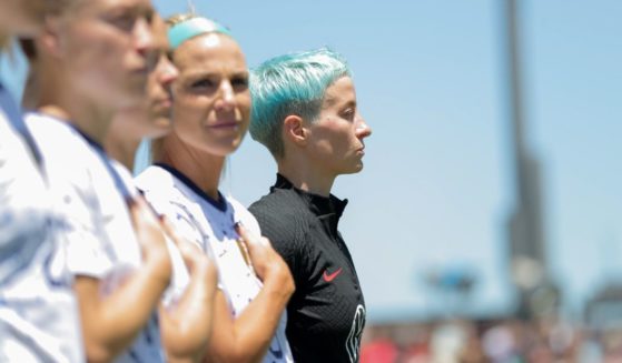 Megan Rapinoe, right, stands with her USWNT teammates during the national anthem before an international friendly game against Wales at PayPal Park in San Jose, California, on Sunday.