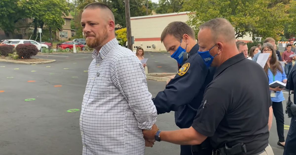 Gabriel Rench is arrested during a "psalm sing" protest in Moscow, Idaho, in 2020.
