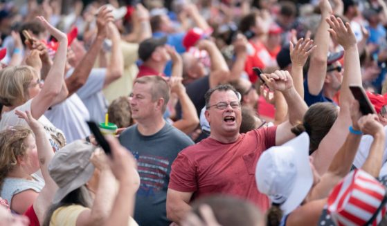 Supporters for former President Donald Trump react to his plan flying overhead before a campaign event in Pickens, South Carolina, on Saturday.