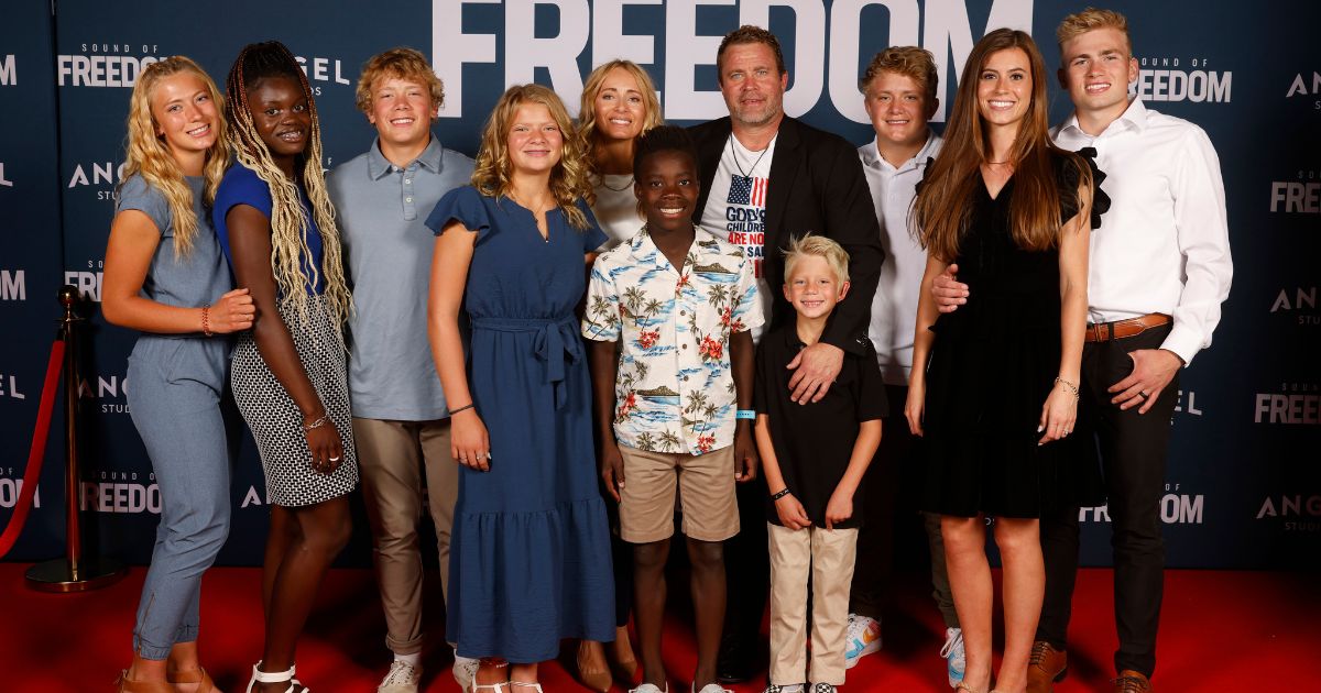 Tim Ballard, middle, who the movie "Sound of Freedom" is based on, attends the movie premier in Vineyard, Utah, with family and friends on June 28.