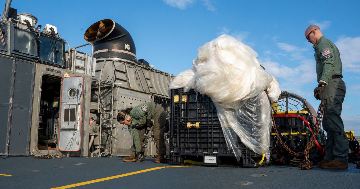 n this U.S. Navy handout, sailors prepare to transport the remains of a high-altitude balloon shot down over the Atlantic Ocean on Feb. 10.