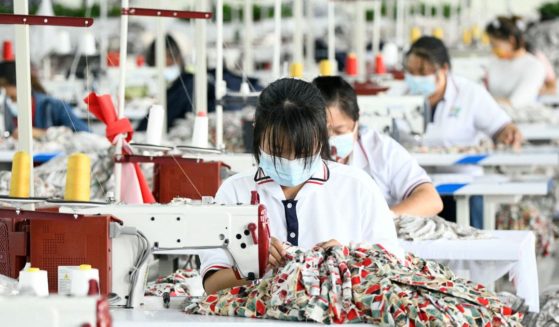 Employees work at a Chinese textile factory in an undated file photo. A new lawsuit charges that a Chinese company is violating copywright law by duplicating U.S. designs and selling the products back to Americans.