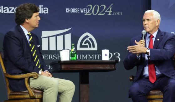 Tucker Carlson, left, interviews Republican presidential candidate and former Vice President Mike Pence at the Family Leadership Summit in Des Moines, Iowa, on July 14.