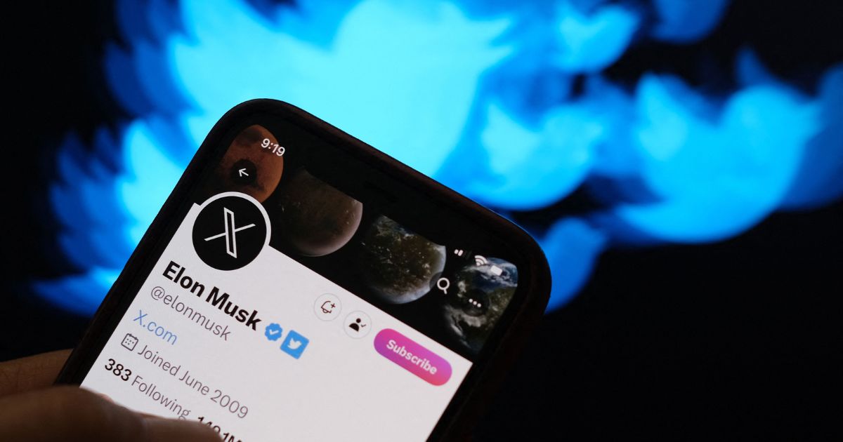 This illustration photo shows the Twitter bird logo in the background of the Twitter page of Elon Musk.