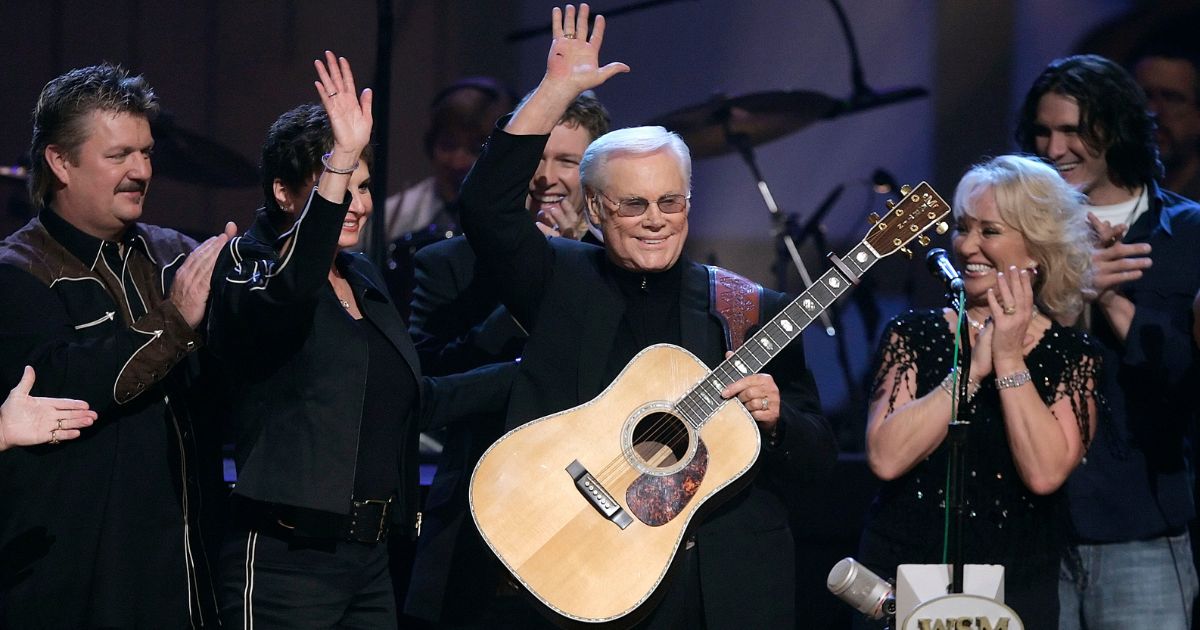 Country music legend George Jones waves to the crowd during his 75th birthday celebration at the Grand Ole Opry House in Nashville, Tennessee, on Sept. 12, 2006. Jones' wife, Nancy, is second from the left. George Jones died in 2013 at the age of 81.