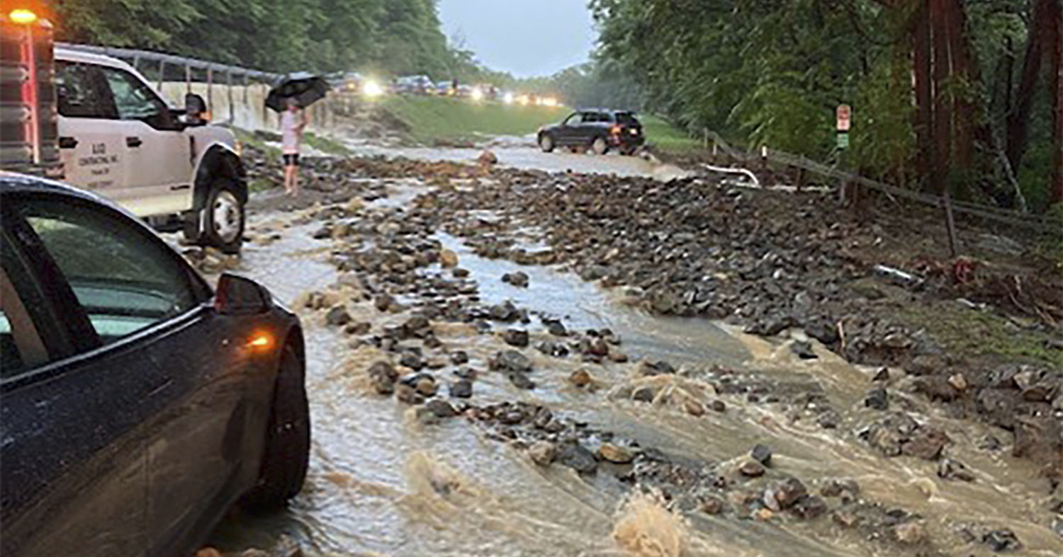 Vehicles come to a standstill near a washed-out and flooded portion of the Palisades Parkway just beyond the traffic circle off the Bear Mountain Bridge in Orange County, New York, on Sunday.