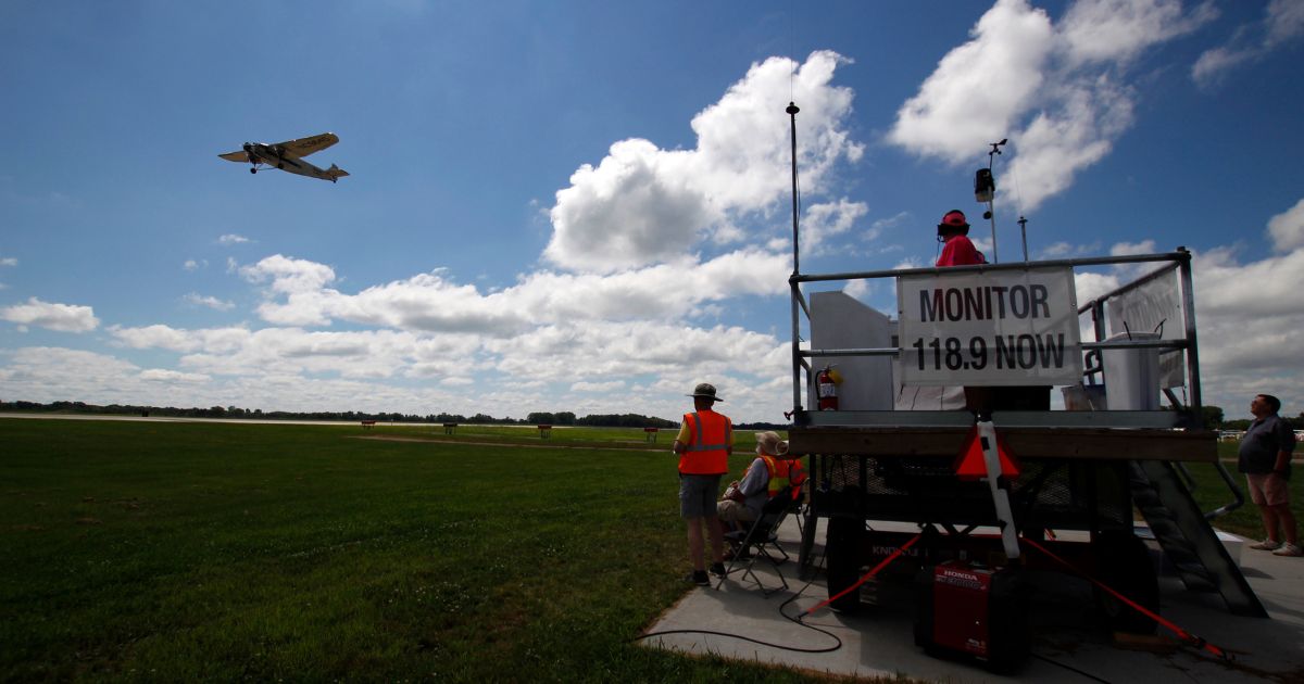 In this photo taken on July 24, 2017, air traffic control workers watch for planes near the runway at Wittman Regional Airport in Oshkosh, Wisconsin.