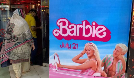 Moviegoers walk past the poster of the movie "Barbie" at a cineplex in Islamabad on Friday.
