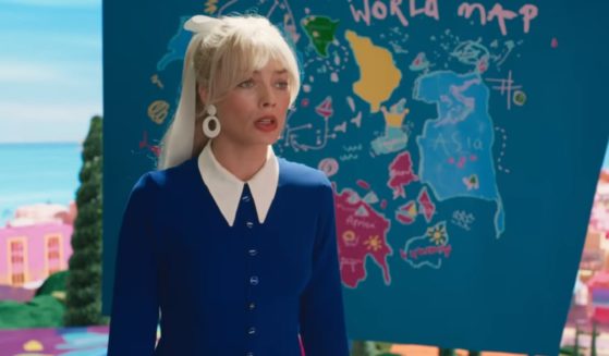 Margot Robbie, as "Barbie," stands in front of a crude world map. Dashes on the map have provoked controversy.