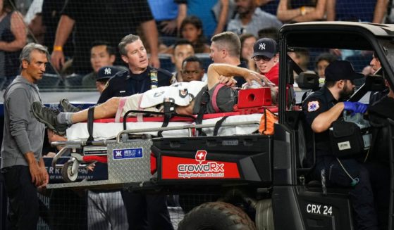 A camera operator who was injured on a throwing error by Baltimore Orioles' Gunnar Henderson has been placed on a cart during the fifth inning of the Orioles' baseball game against the New York Yankees on Wednesday in New York.
