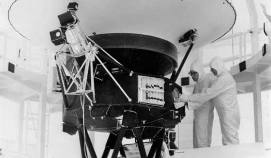 In this Aug. 4, 1977, the "Sounds of Earth" record is mounted on the Voyager 2 spacecraft in the Safe-1 Building at the Kennedy Space Center in Florida prior to encapsulation in the protective shroud.