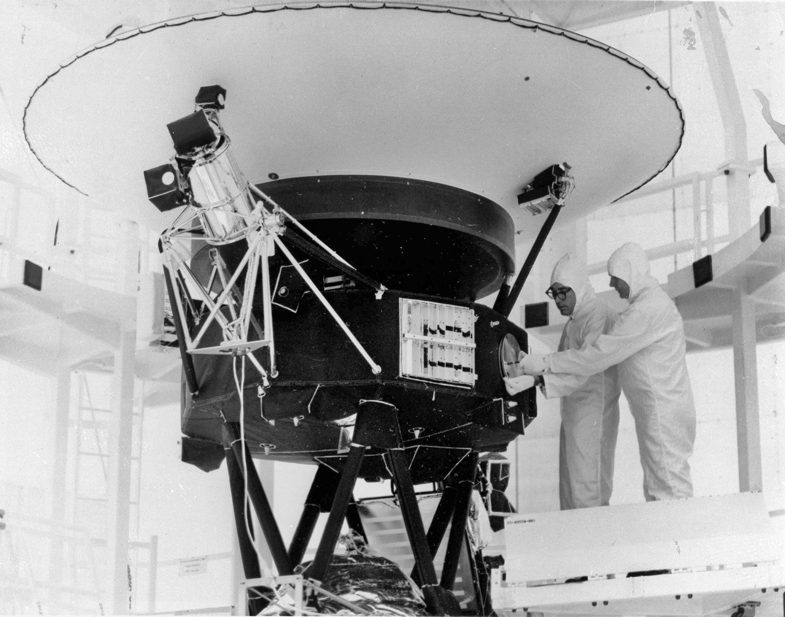 In this Aug. 4, 1977, the "Sounds of Earth" record is mounted on the Voyager 2 spacecraft in the Safe-1 Building at the Kennedy Space Center in Florida prior to encapsulation in the protective shroud.