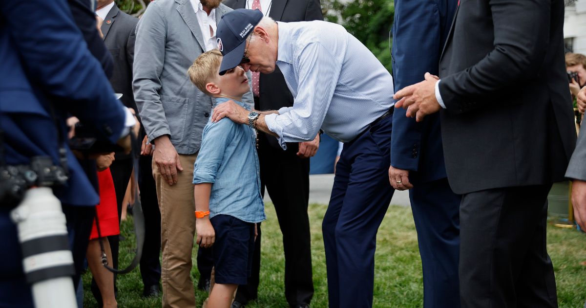 President Joe Biden talks with children during the Congressional Picnic on the South Lawn of the White House on July 12, 2022, in Washington, D.C.