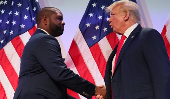 U.S. Rep. Byron Donalds of Florida shakes hands with former President Donald Trump during the Moms for Liberty Joyful Warriors national summit on June 30 in Philadelphia.