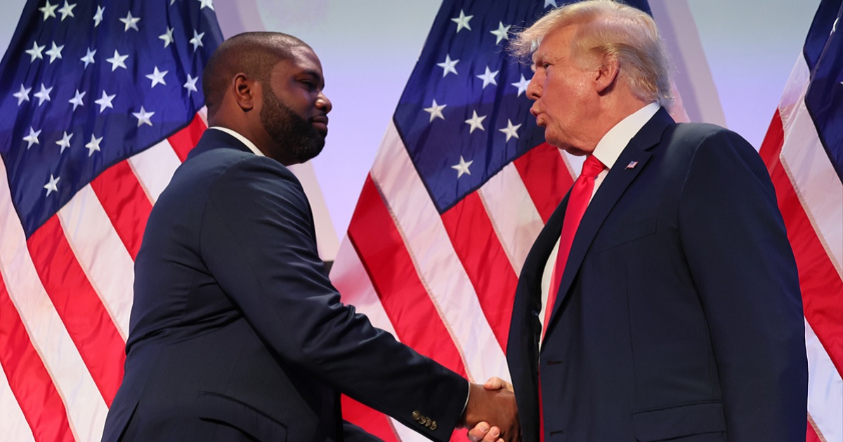 U.S. Rep. Byron Donalds of Florida shakes hands with former President Donald Trump during the Moms for Liberty Joyful Warriors national summit on June 30 in Philadelphia.