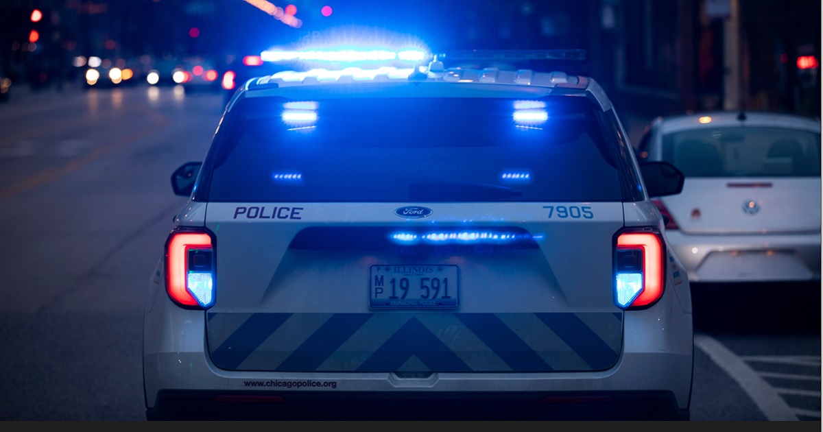 A Chicago Police Department vehicle with lights flashing responds to a night call.