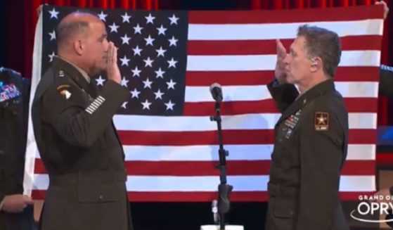 Army Gen. Andrew Poppas, left, swears in country star Craig Moran for another tour with the U.S. Army Reserves on Saturday at the Grand Ole Opry in Nashville. (ChiefUSAR / Twitter)