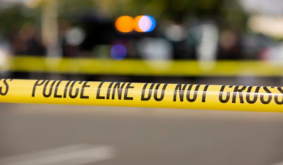 A stock photo shows yellow police tape blocking off a crime scene.