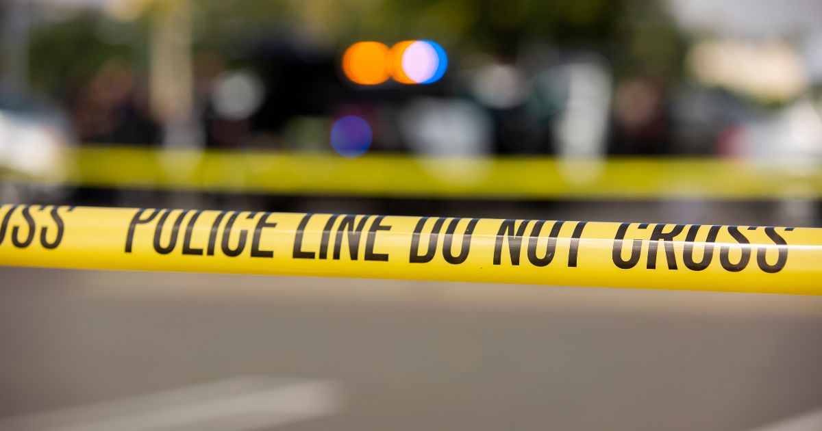 A stock photo shows yellow police tape blocking off a crime scene.