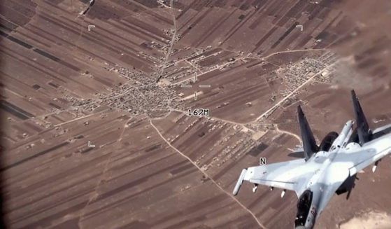 In this image from a video released by the U.S. Air Force, a Russian Su-35 flies near a U.S. Air Force MQ-9 Reaper drone on July 5, over Syria.