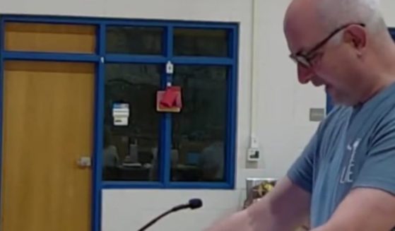 A dad throws chicken feed at a South Carolina school board to protest sexually explicit books.
