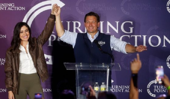 Florida Gov. Ron DeSantis lifts an arm in greeting in a file photo with U.S. Rep. Anna Paulina Luna, a Florida Republican.