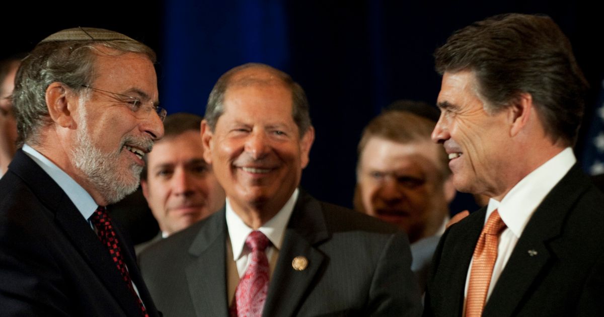 Rick Perry (R) shakes hands with Assemblyman Dov Hikind after Hikind's speech at a rally with American and Israeli-Jewish leaders September 20, 2011 in New York. With a Palestinian push for statehood at the United Nations Rick Perry attended the rally against the measure. Center is congressman Bob Turner.