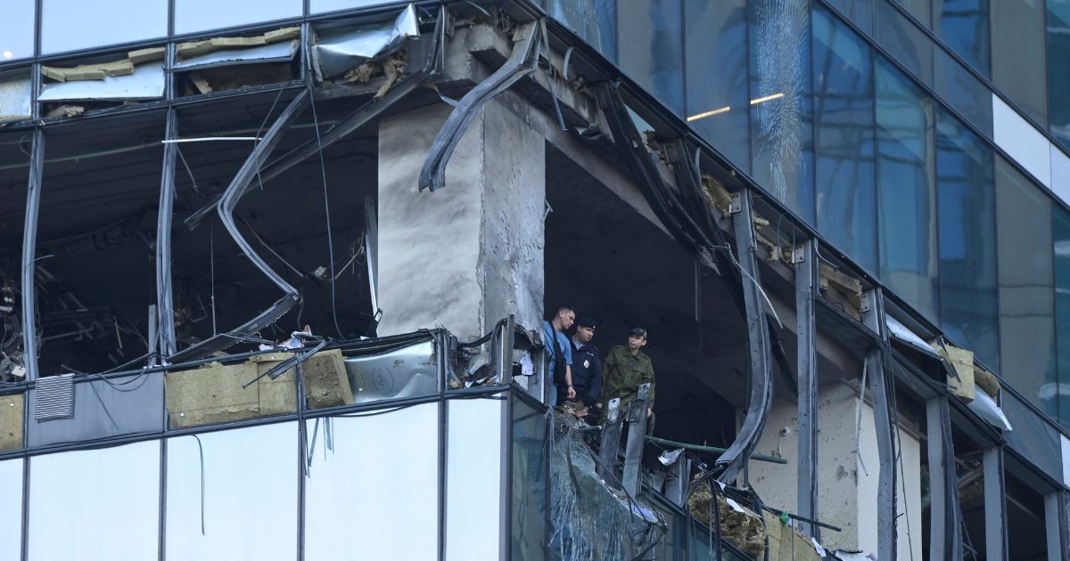 Investigators examine a damaged skyscraper in the "Moscow City" business district after a reported drone attack in Moscow on Sunday.