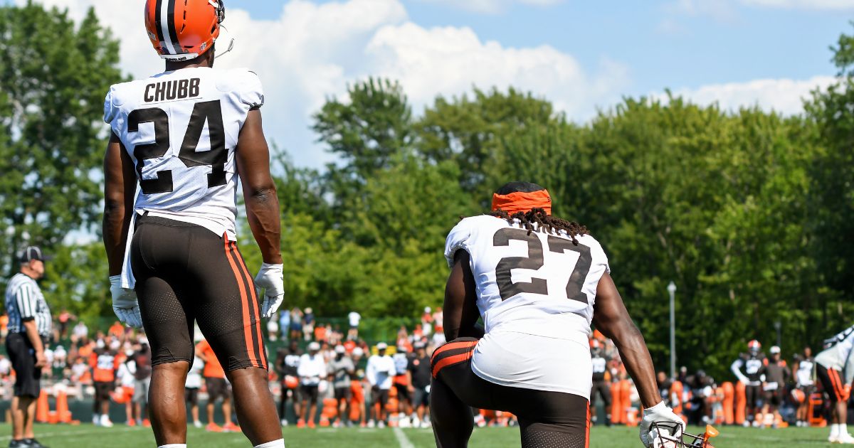 Running backs Nick Chubb #24 and Kareem Hunt #27 of the Cleveland Browns watch a drill during Cleveland Browns Training Camp on Aug. 3, 2021, in Berea, Ohio.