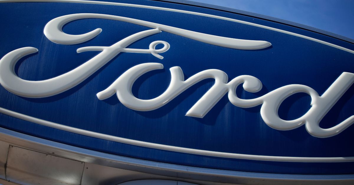 This photo shows a Ford company logo on a sign at a Ford dealership in southeast Denver on Oct. 24, 2021.