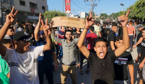 Palestinian demonstrators chant slogans during a protest against the territory's chronic power outages and difficult living conditions along the streets of Khan Younis, southern Gaza Strip, on Sunday.