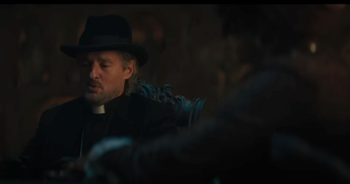 In this screenshot from the new “Haunted Mansion” trailer, Owen Wilson, who plays Father Kent in the movie, is seen in conversation with another character.