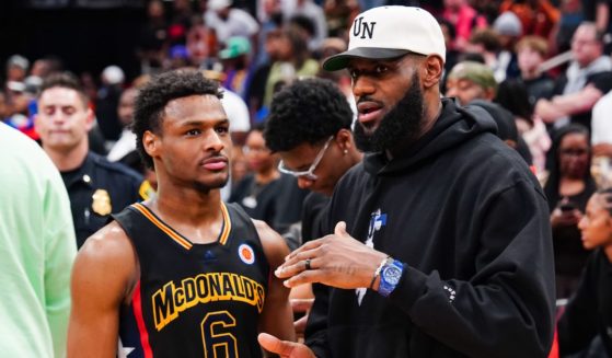 Bronny James #6 of the West team talks to Lebron James of the Los Angeles Lakers after the 2023 McDonald's High School Boys All-American Game at Toyota Center on March 28 in Houston, Texas.