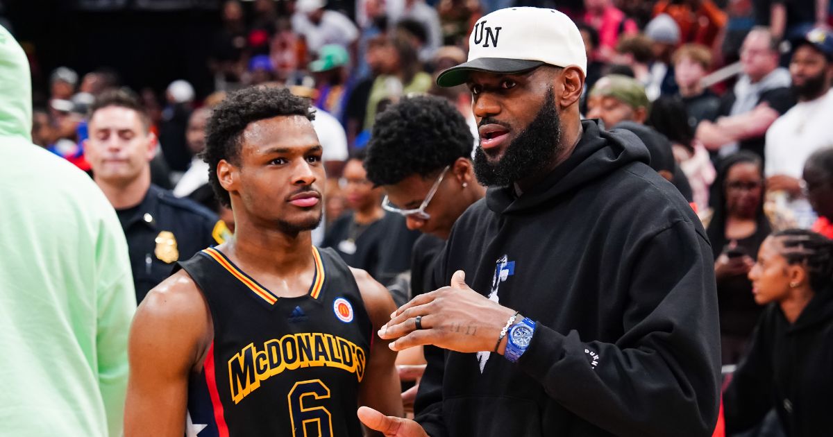 Bronny James #6 of the West team talks to Lebron James of the Los Angeles Lakers after the 2023 McDonald's High School Boys All-American Game at Toyota Center on March 28 in Houston, Texas.