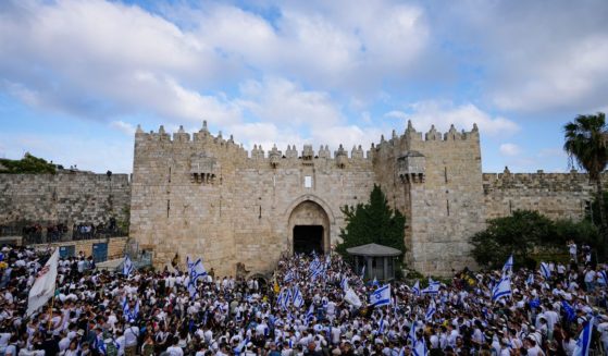 Israelis dance and wave national flags during a march marking Jerusalem Day, an Israeli holiday celebrating the capture of east Jerusalem in the 1967 Mideast War, in front of the Damascus Gate of Jerusalem's Old City on May 18.