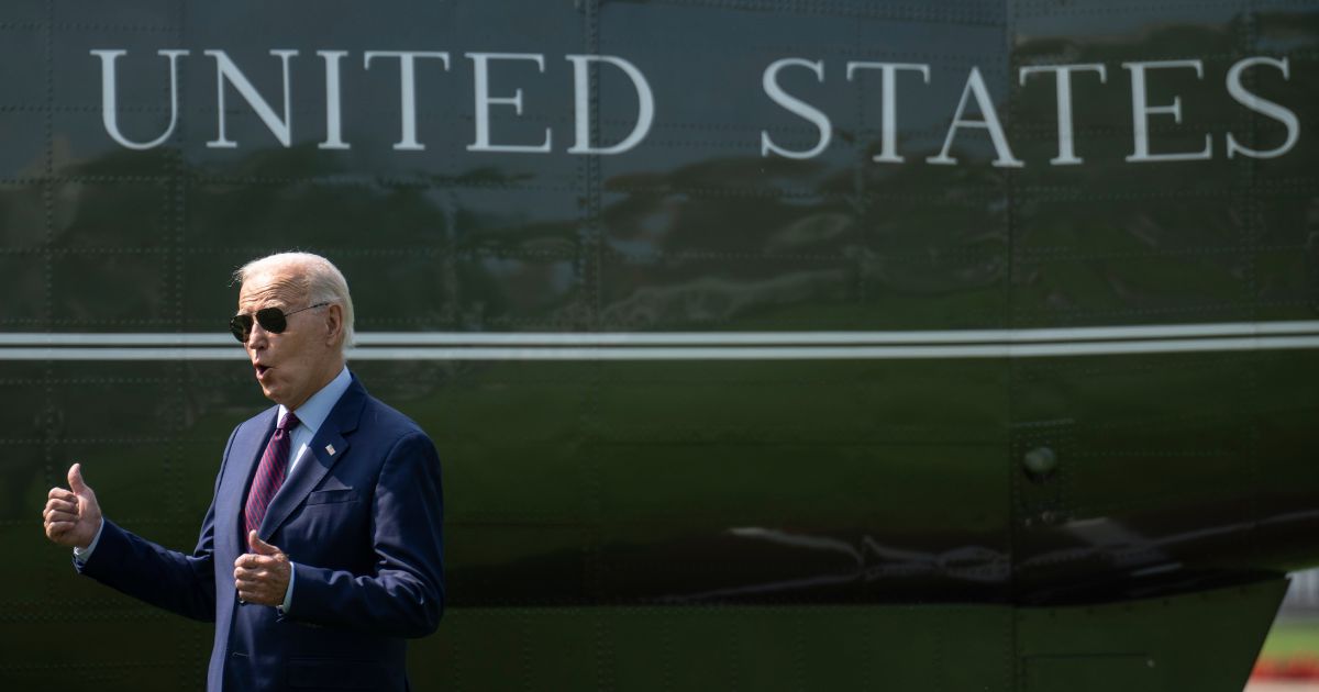 U.S. President Joe Biden gestures toward visitors watching the departure as he walks to Marine One on the South Lawn of the White House July 28, 2023 in Washington, DC.