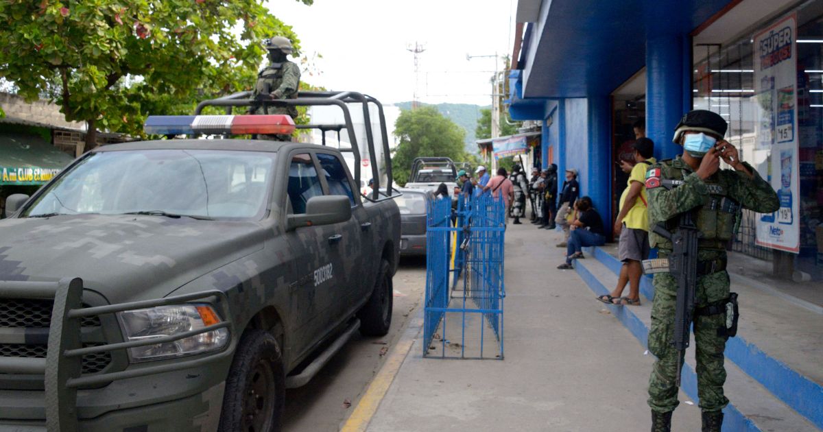 Mexican Army soldiers check the area where Mexican journalist Nelson Mateus was murdered in the resort town of Acapulco, Guerrero state, Mexico, on Saturday.